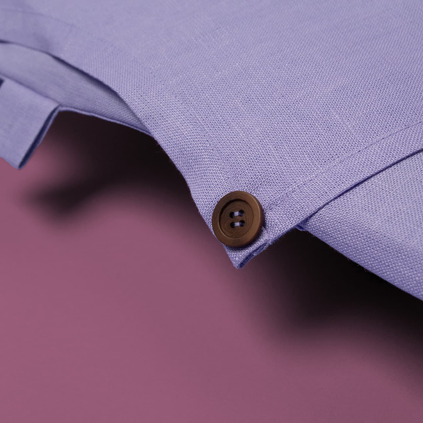 Apron detail shot: light purple color, button