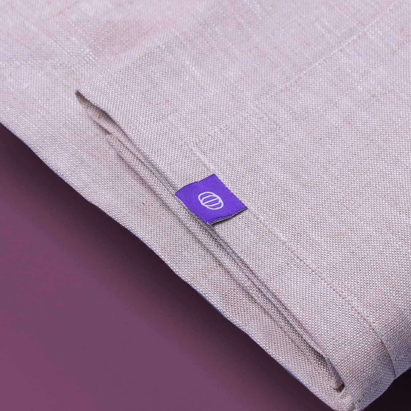 Apron detail shot: light purple color, folded, tines tag