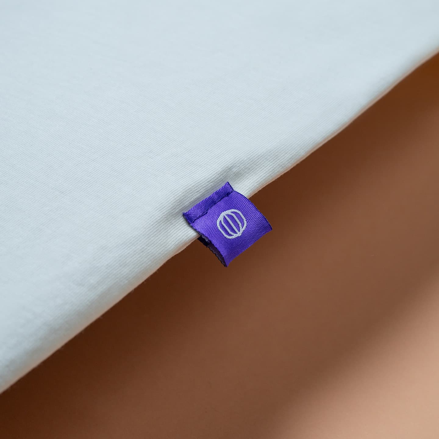 Close-up photo of the Tines tag on the side of the Woof T-shirt